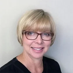 A headshot photo of Kathy, the practice manager at Evolve Dental